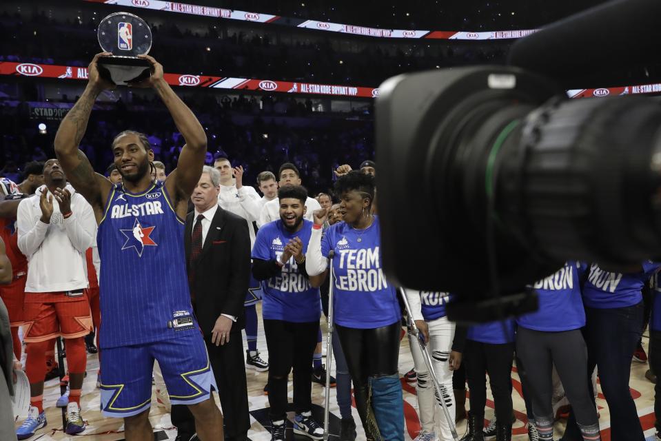 Kawhi Leonard of the Los Angeles Clippers holds up his NBA All-Star Game Kobe Bryant MVP Award after the NBA All-Star basketball game Sunday, Feb. 16, 2020, in Chicago. (AP Photo/Nam Huh)