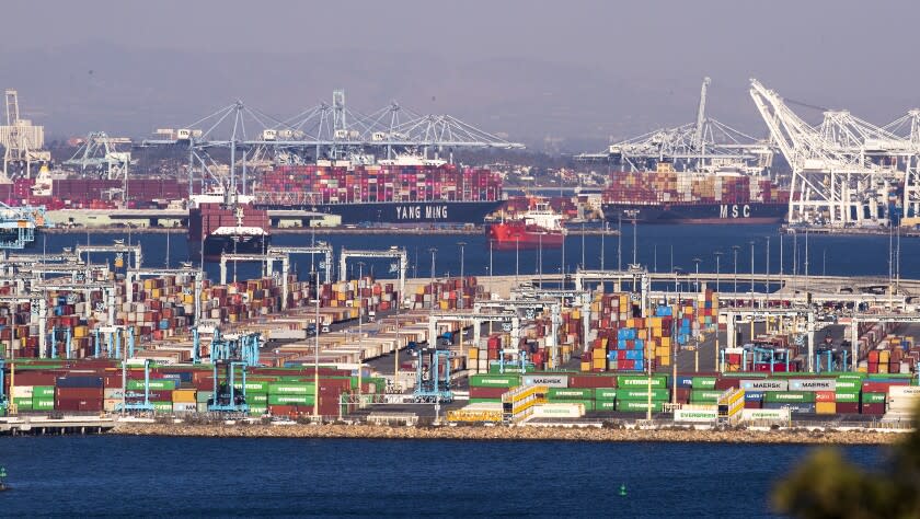 Los Angeles CA - October 13 Thousands of containers sit, waiting to be loaded on trucks and trains, as large container ships are unloaded from the Ports of Los Angeles and Long Beach, while dozens of large container ships wait to be unloaded offshore Wednesday, Oct. 13, 2021. President Biden is set to announce Wednesday that the Port of Los Angeles would operate around the clock to alleviate a logistical bottleneck that has left dozens of container ships idling off the California coast and Americans waiting longer to get products manufactured overseas. The agreement to have longshoremen unloading cargo through the night is intended to speed the flow of toys, electronics and other gifts to American doorsteps during the holiday season. (Allen J. Schaben / Los Angeles Times)