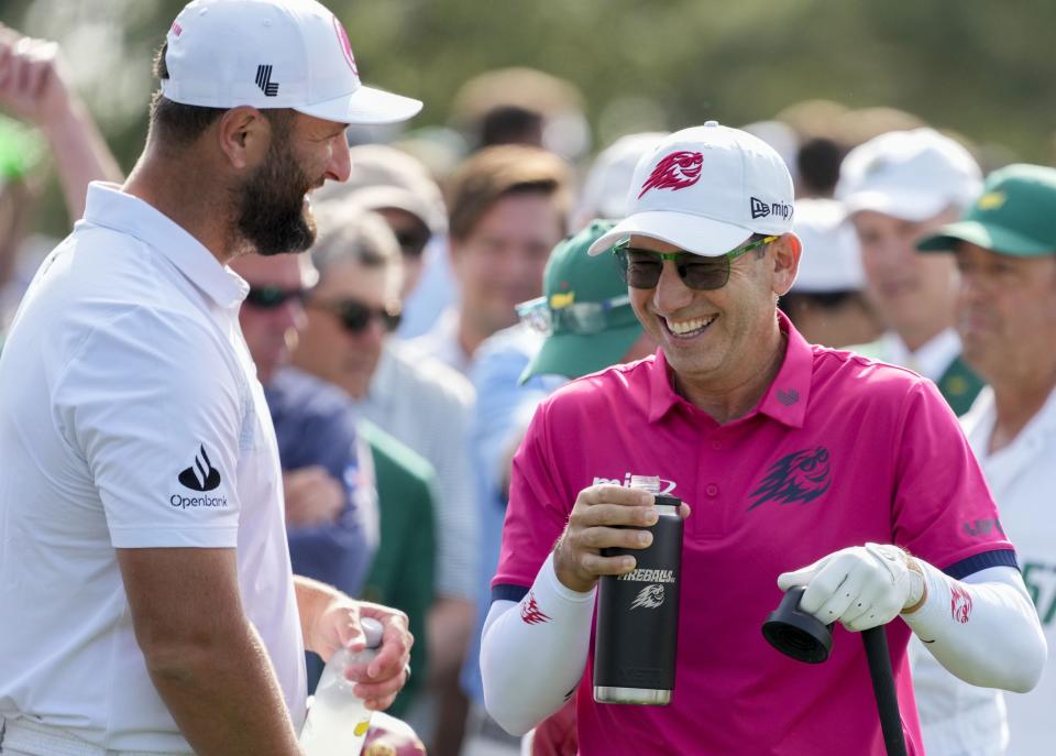 Apr 10, 2024; Augusta, Georgia, USA; Jon Rahm and Sergio Garcia laugh at the no. 1 tee during a practice round at Augusta National Golf Club. Mandatory Credit: Michael Madrid-USA TODAY Network