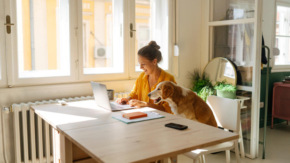 Woman working from home with her dog