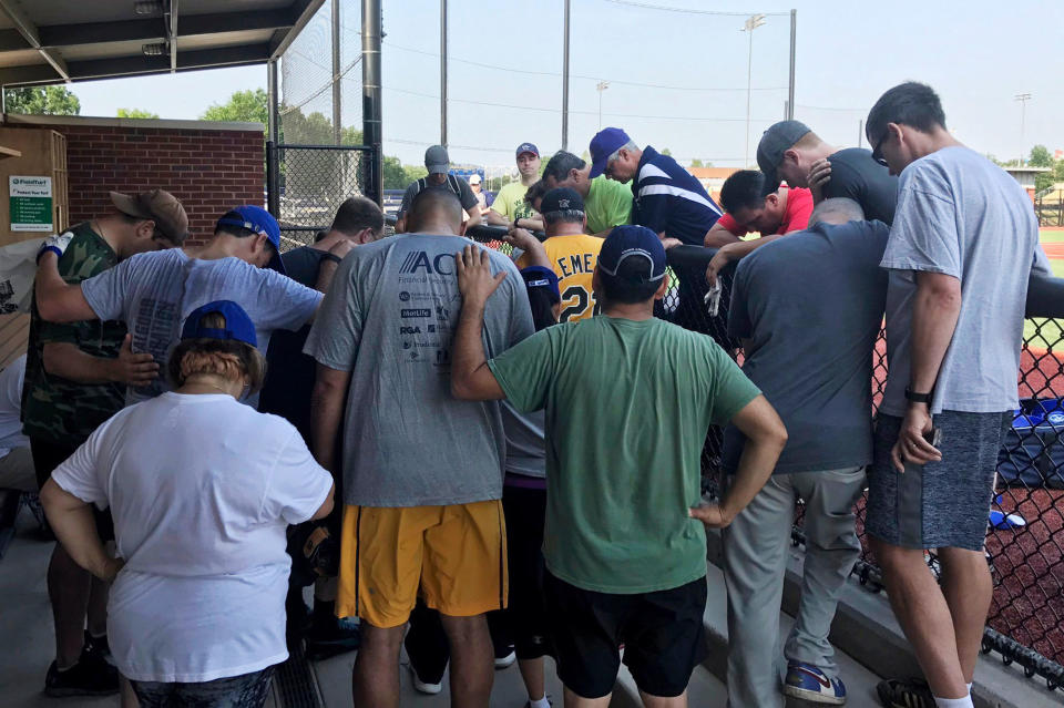 <p>House Democrats at a baseball field in Washington pray for their colleagues after hearing that a gunman fired on Republican lawmakers at a baseball practice in Alexandria, Va., Wednesday, June 14, 2017. A rifle-wielding attacker wounded House GOP Whip Steve Scalise of Louisiana and several others as congressmen and aides dove for cover. (Rep. Ruben J. Kihuen via AP) </p>