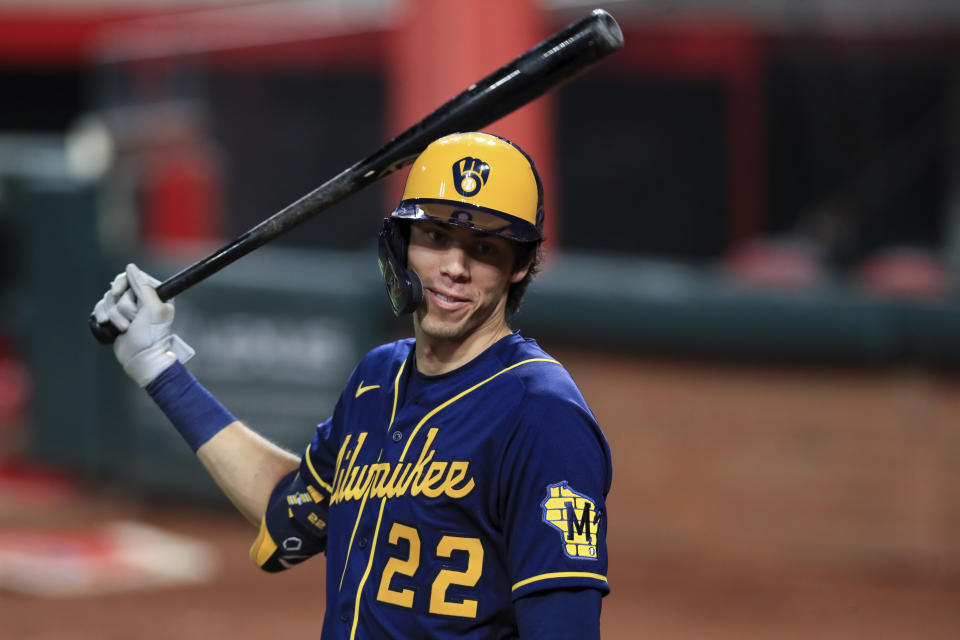 FILE - Milwaukee Brewers' Christian Yelich waits to bat during a baseball game against the Cincinnati Reds in Cincinnati, in this Monday, Sept. 21, 2020, file photo. The average Major League Baseball salary dropped for an unprecedented third straight year, even before the shortened season caused by the novel coronavirus pandemic. Last year’s drop showed the widening imbalance between top stars and other players. The average fell despite Gerrit Cole, Stephen Strasburg, Anthony Rendon and Christian Yelich all starting long-term contracts guaranteeing $215 million or more. (AP Photo/Aaron Doster, File)