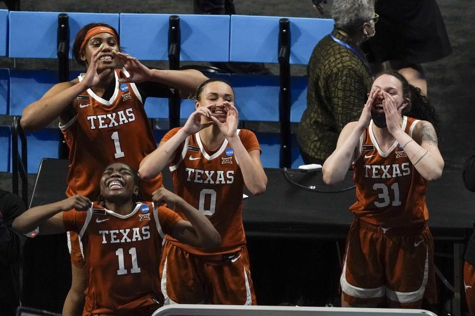 Texas's Lauren Ebo (1), Joanne Allen-Taylor (11), Celeste Taylor and Audrey Warren celebrate after an NCAA college basketball game against Maryland in the Sweet 16 round of the Women's NCAA tournament Sunday, March 28, 2021, at the Alamodome in San Antonio. Texas won 64-61. (AP Photo/Morry Gash)