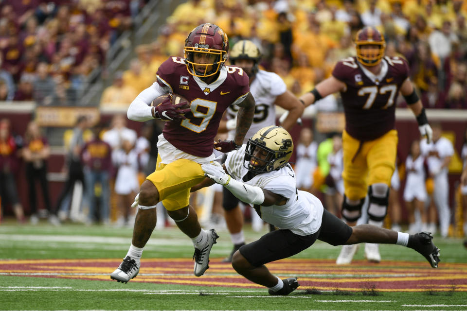 Minnesota wide receiver Daniel Jackson (9) slips past Purdue safety Chris Jefferson for a first down during the first half an NCAA college football game on Saturday, Oct. 1, 2022, in Minneapolis. Purdue won 20-10. (AP Photo/Craig Lassig)