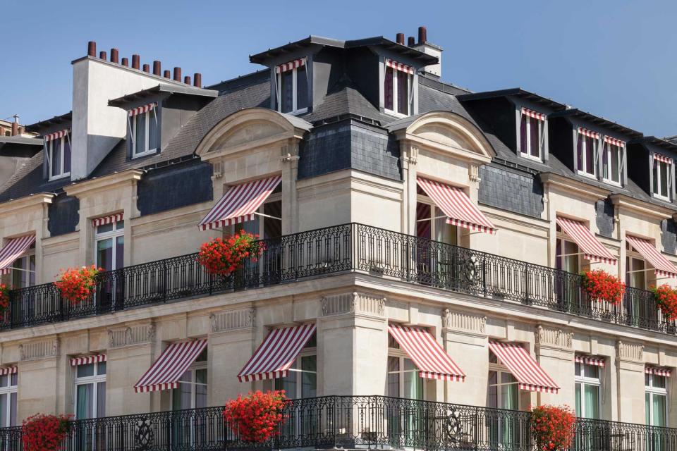 Exterior of the Le Bristol hotel in Paris, with its signature red and white striped awnings