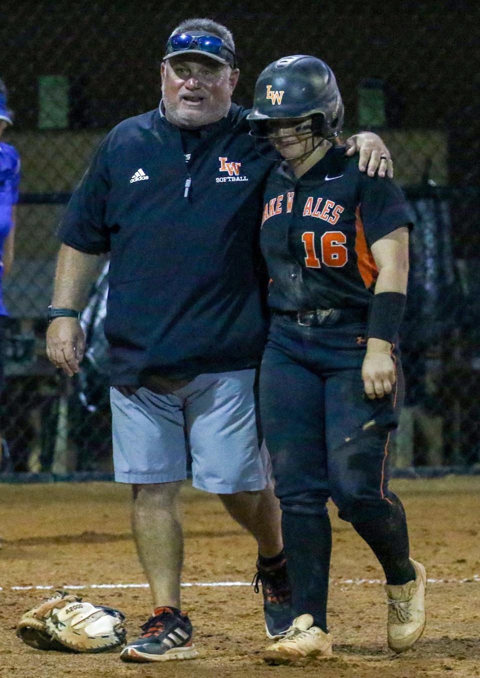 Lake Wales coach Mike Settle consoles third baseman Lydia Denton after the final out against Deltona in the Class 4A state championshipp softball game at Legends Way Ballfields in Clermonty.