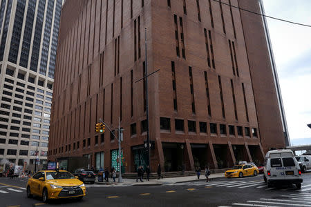 People are seen outside the building where American Media Inc. (AMI) is headquartered in New York City, New York, U.S., February 8, 2019. REUTERS/Brendan McDermid