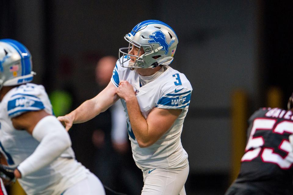 Detroit Lions punter Jack Fox (3) throws a pass for a first down during the first half Sunday, Dec. 26, 2021, in Atlanta.