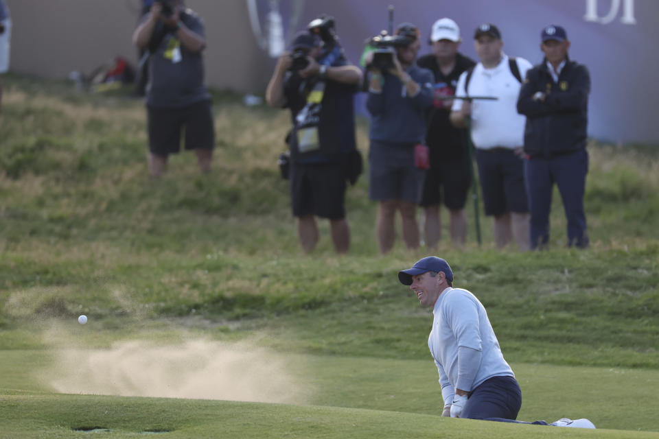 Northern Ireland's Rory McIlroy plays out of a bunker on the 18th green on the first day of the British Open Golf Championships at the Royal Liverpool Golf Club in Hoylake, England, Thursday, July 20, 2023. (AP Photo/Peter Morrison)