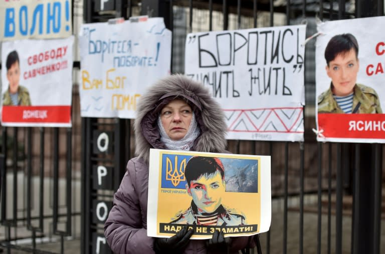 A woman holds a portrait of Ukrainian military pilot Nadiya Savchenko during a demonstration in front of the Russian embassy in Kiev on March 22, 2016
