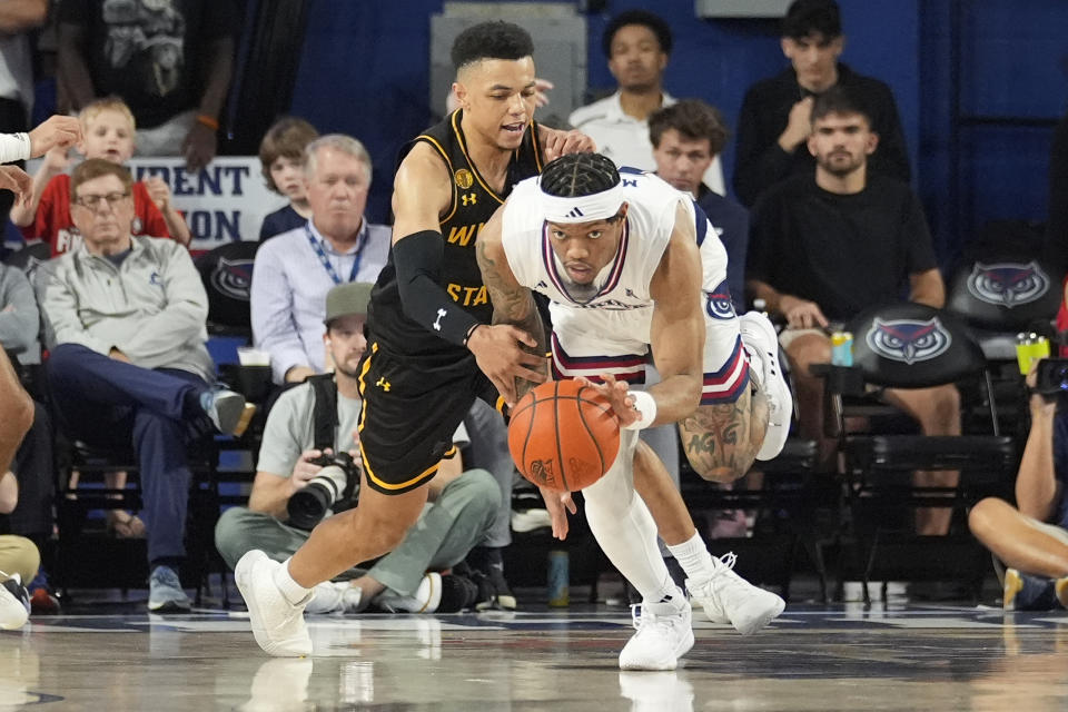 Florida Atlantic guard Alijah Martin (15) grabs the ball from Wichita State guard Xavier Bell (1) during the first half of an NCAA college basketball game, Thursday, Jan. 18, 2024, in Boca Raton, Fla. (AP Photo/Marta Lavandier)