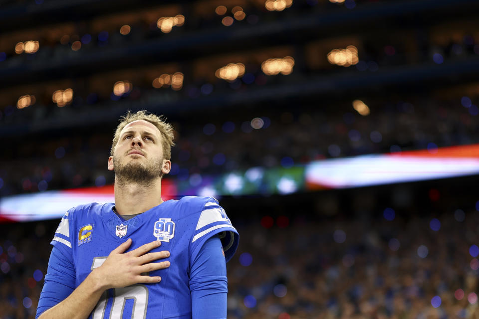 DETROIT, MI - JANUARY 21: Jared Goff #16 of the Detroit Lions stands on the sidelines during the national anthem prior to an NFL divisional round playoff football game against the Tampa Bay Buccaneers at Ford Field on January 21, 2024 in Detroit, Michigan. (Photo by Kevin Sabitus/Getty Images)