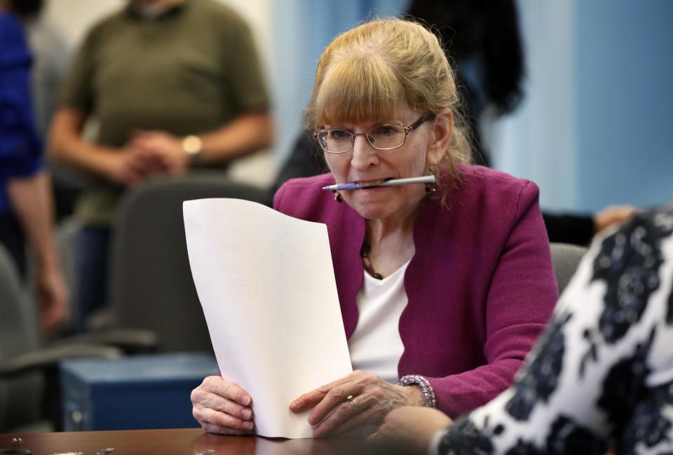 Deputy Secretary of State Julie Flynn looks over papers during the ballot-tabulation process for Maine's Second Congressional District's House election Monday, Nov. 12, 2018, in Augusta, Maine. The election is the first congressional race in American history to be decided by the ranked-choice voting method that allows second choices. (AP Photo/Robert F. Bukaty)