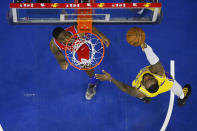 Los Angeles Lakers' LeBron James, right, puts up the ball with Philadelphia 76ers' Shake Milton, left, defending during the second half of an NBA basketball game, Saturday, Jan. 25, 2020, in Philadelphia. LeBron James passes Kobe Bryant for third on the NBA all-time scoring. (AP Photo/Chris Szagola)