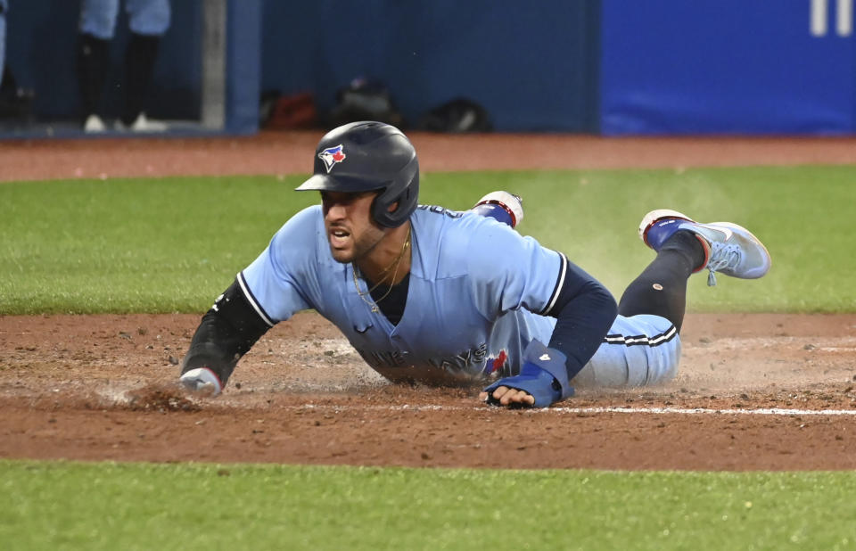 Toronto Blue Jays' George Springer scores on a single by Bo Bichette in the third inning of a baseball game against Baltimore Orioles in Toronto on Sunday, Sept 18, 2022. (Jon Blacker/The Canadian Press via AP)