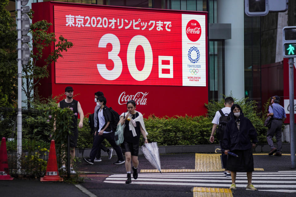 A countdown clock shows 30 days to the opening ceremony of the Tokyo 2020 Olympic Games Wednesday, June 23, 2021, in Tokyo. (AP Photo/Kiichiro Sato)