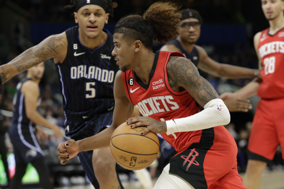 Houston Rockets guard Jalen Green (4) drives against Orlando Magic forward Paolo Banchero (5) during the first half of an NBA basketball game, Monday, Nov. 7, 2022, in Orlando, Fla. (AP Photo/Kevin Kolczynski)