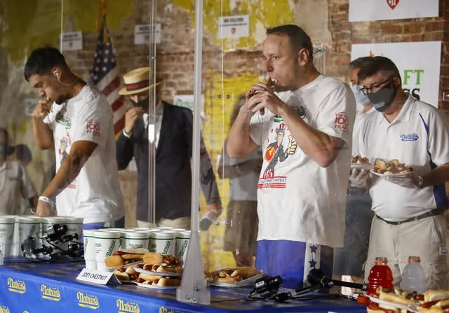 Competitive eater Joey Chestnut sets a new world record with 75 hot dogs to win the men’s division of the Nathan’s Famous July Fourth hot dog eating contest, Saturday, July 4, 2020, in the Brooklyn borough of New York