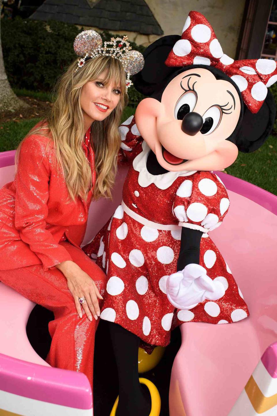 <p>The supermodel is a Disney parks regular — frequently visiting with her four kids — and now she's a mouse ear designer, too! She recently visited Disneyland to debut a high-fashion headpiece and stopped for a photo opp with Minnie Mouse in a teacup. Just 500 of the limited-edition bands were made and each is studded with 150 Swarovski crystals and costs $600. They're available for purchase at Disneyland Resort in California, Walt Disney World Resort in Florida and on shopdisney.com.</p>