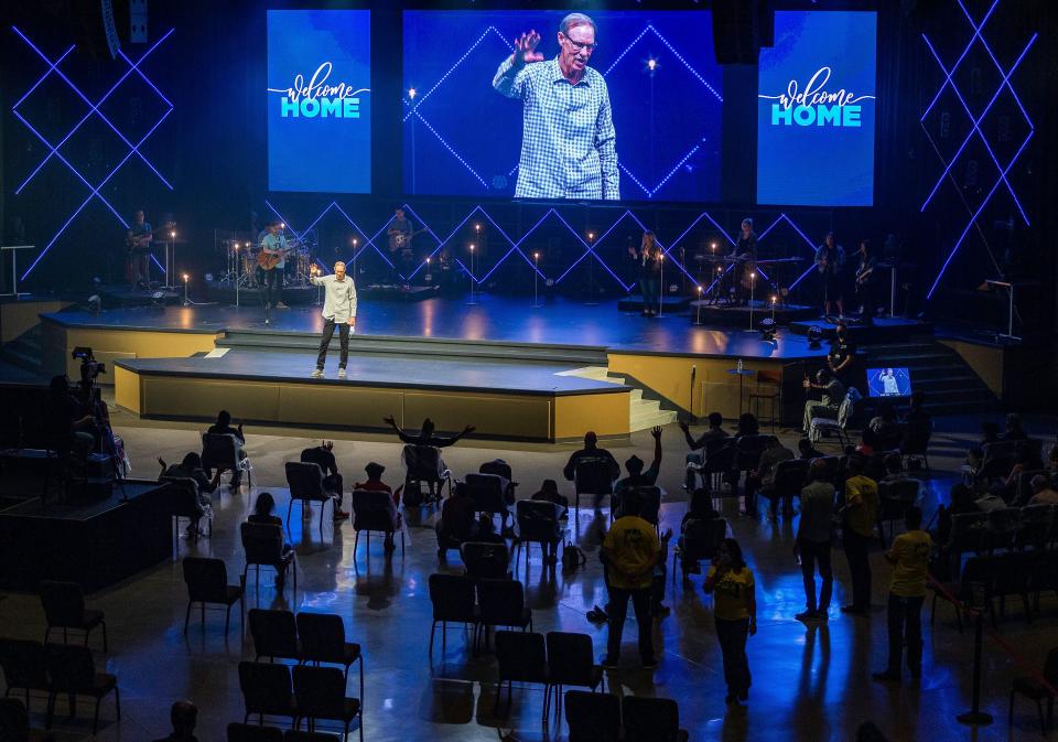 Pastor Danny Carroll, of California's Water of Life Community Church, prays during a service on Sunday, May 31. ((AP Photo/Damian Dovarganes))