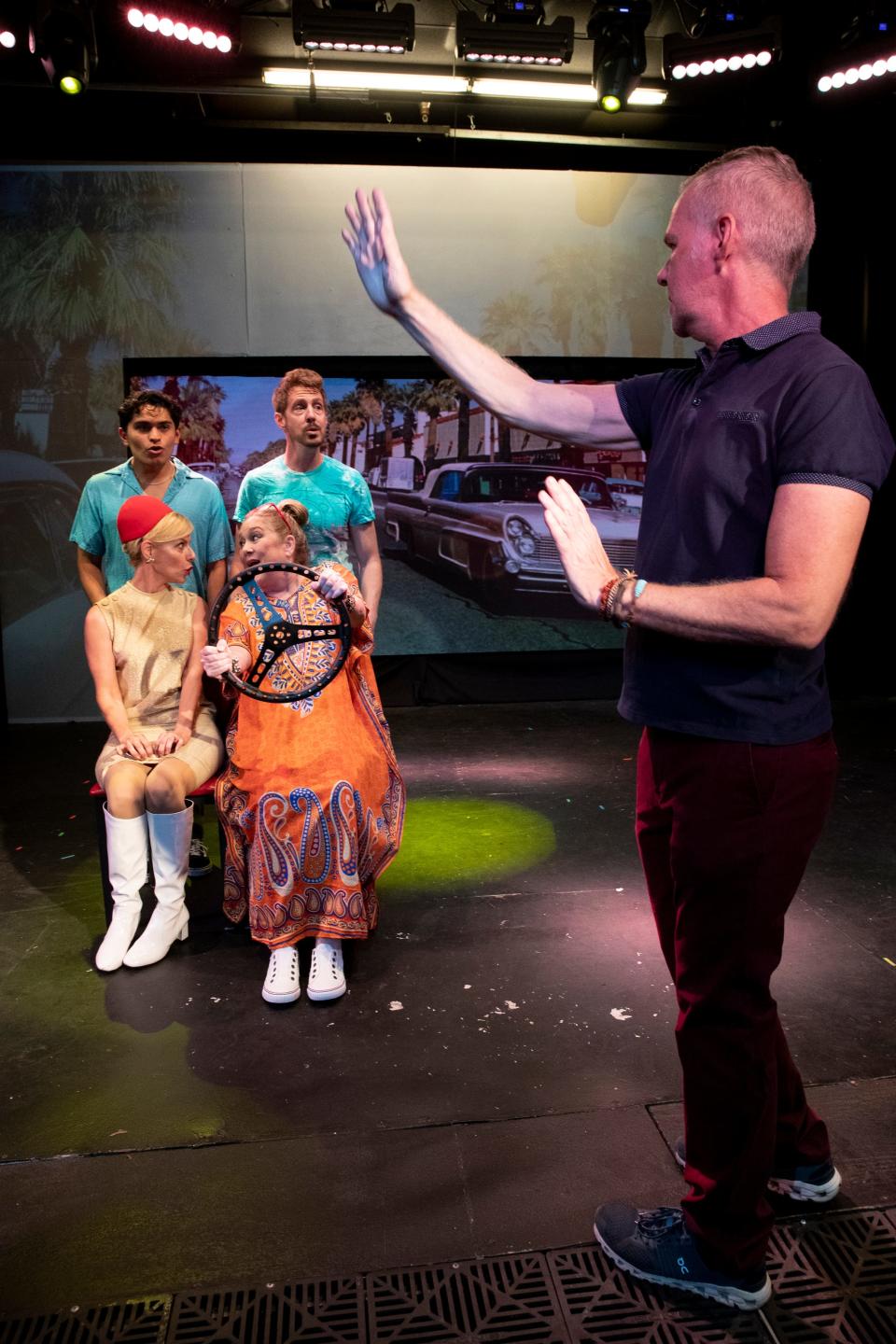 Cast members Carlos Garcia, standing left, James Owens, Christine Tringali Nunes, sitting left, and Dana Adkins rehearse with director Mark Christopher for the debut of his play, 'Mid-Century Moderns,' at the Desert Rose Playhouse in Palm Springs, Calif., on April 5, 2022. 