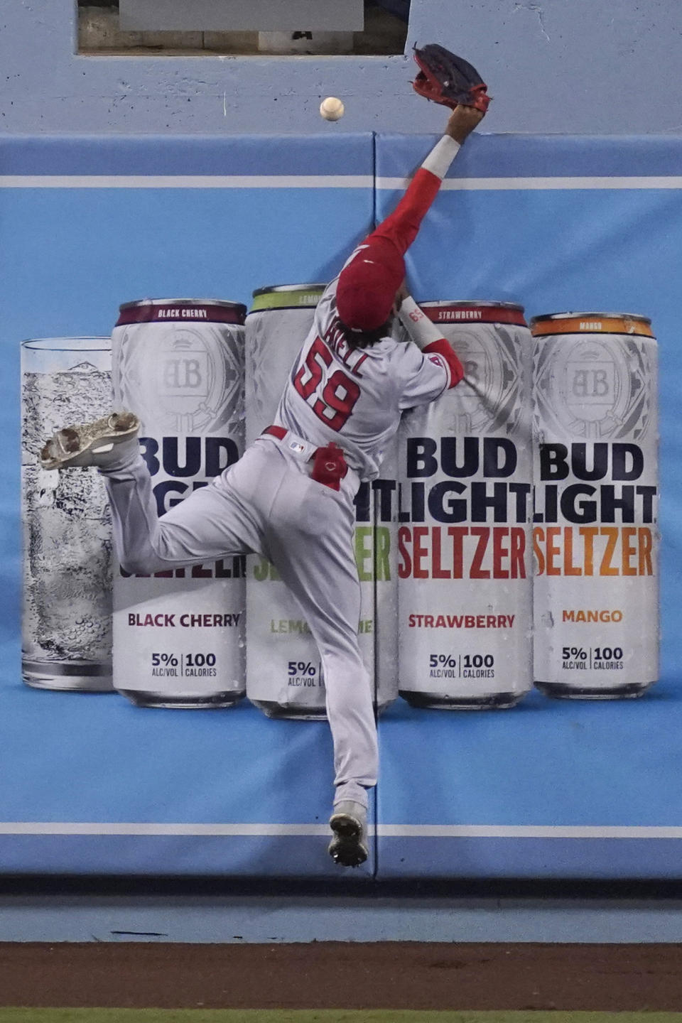 Los Angeles Angels center fielder Jo Adell can't make a catch on a home run by Los Angeles Dodgers' Edwin Rios during the seventh inning of a baseball game Saturday, Sept. 26, 2020, in Los Angeles. (AP Photo/Ashley Landis)