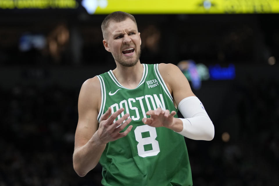 Boston Celtics center Kristaps Porzingis gestures toward a referee during the first half of an NBA basketball game against the Minnesota Timberwolves, Monday, Nov. 6, 2023, in Minneapolis. (AP Photo/Abbie Parr)