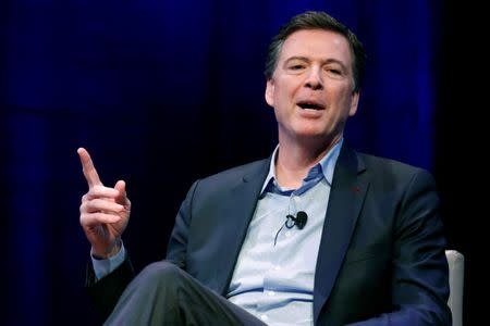 FILE PHOTO: Former FBI director James Comey speaks about his book during an onstage interview with Axios Executive Editor Mike Allen at George Washington University in Washington, U.S. April 30, 2018. REUTERS/Jonathan Ernst