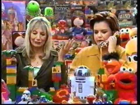 Penny Marshall and Rosie O'Donnell sitting surrounded by toys