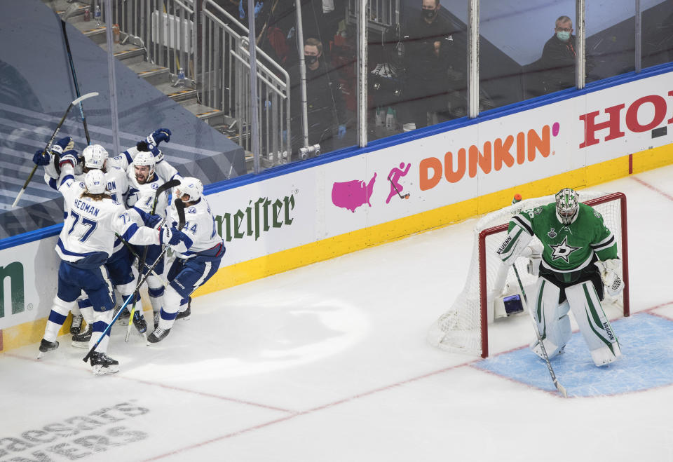 Tampa Bay Lightning center Steven Stamkos, obscured, is congratulated for his goal against Dallas Stars goaltender Anton Khudobin (35) during the first period of Game 3 of the NHL hockey Stanley Cup Final, Wednesday, Sept. 23, 2020, in Edmonton, Alberta. (Jason Franson/The Canadian Press via AP)