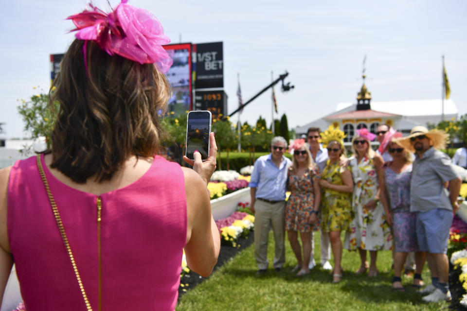 People pose for a photograph prior to the 147th running of the Preakness Stakes horse race at Pimlico Race Course, Saturday, May 21, 2022, in Baltimore. (AP Photo/Terrance Williams)