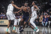 New Orleans Pelicans' Zion Williamson, center, drives to the basket between Brooklyn Nets defenders Mikal Bridges, left, and Day'Ron Sharpe during the second half of an NBA basketball game Tuesday, March 19, 2024, in New York. (AP Photo/Bebeto Matthews)