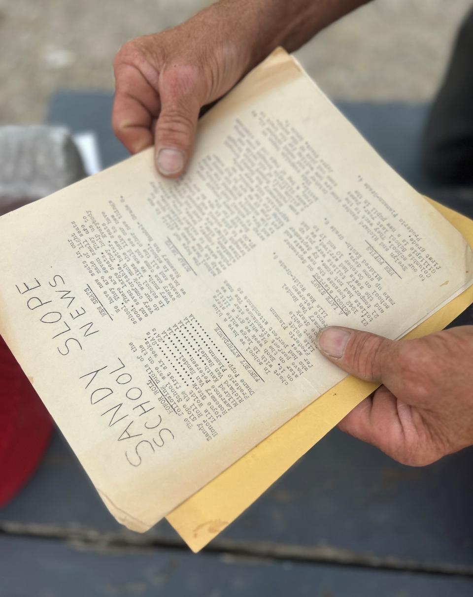 Steve Petersen reads a copy of Sandy Slope School News from his father's time as a student at the rural schoolhouse in Grand Chute.