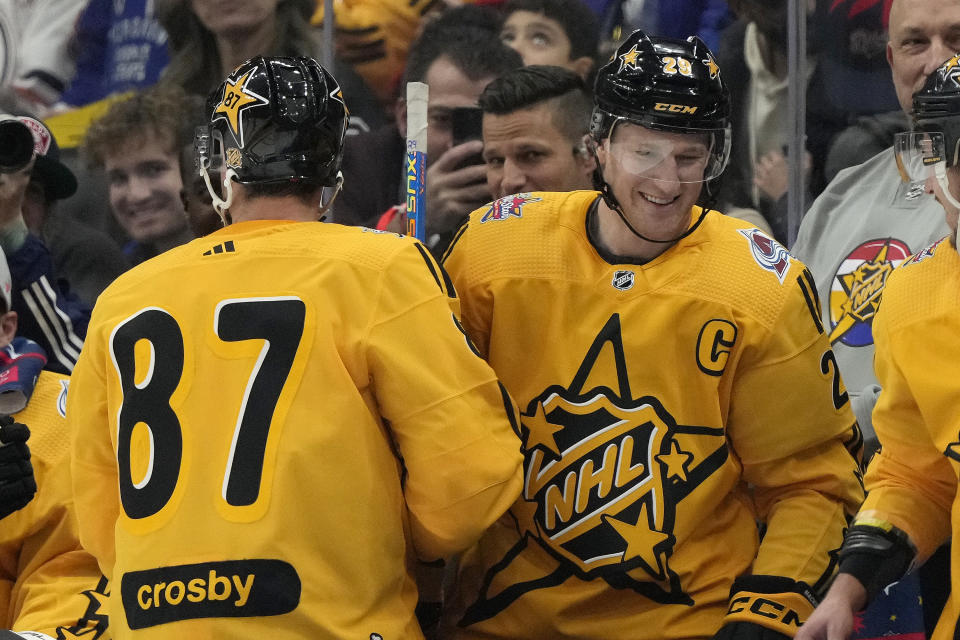 Team MacKinnon captain forward Nathan MacKinnon (29), of the Colorado Avalanche, is congratulated on his goal against Team McDavid by teammate Sidney Crosby (87), of the Pittsburgh Penguins, during the NHL All-Star Game 3-on-3 hockey tournament in Toronto, Ontario, Saturday, Feb. 3, 2024. (Frank Gunn/The Canadian Press via AP)