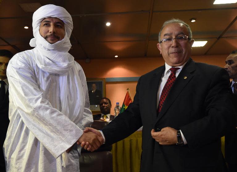 Algerian Foreign Minister Ramtane Lamamra (R) shakes hands with Secretary general of Mali's Tuareg Tuareg National Movement for the Liberation of Azawad (MNLA) group Bilal Ag Acherif after the signing of a peace agreement on February 19, 2015