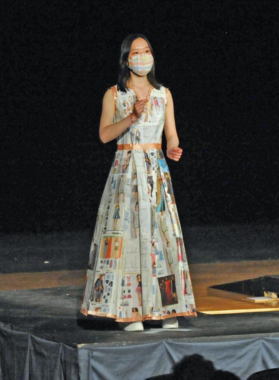 Quincy High School student Gian Zheng models her "eco-friendly" design of recycled materials used to make this dress during the Quincy High School Fashion Show, Thursday, May 12, 2022. Tom Gorman/For The Patriot Ledger