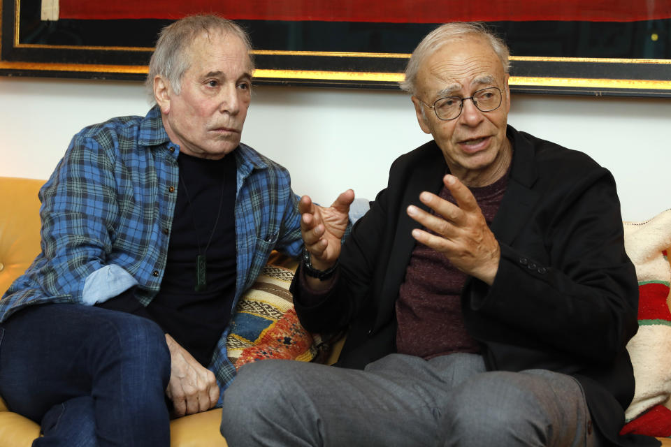 This Nov. 8, 2019 photo shows singer-songwriter, Paul Simon, left, and author-philosopher Peter Singer during an interview in New York to promote the new edition of Singer's book “The Life You Can Save." (AP Photo/Richard Drew)
