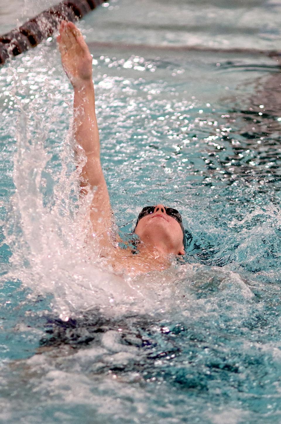 Burlington’s David King swims in the 100-yard backstroke against United Township Friday in Burlington.