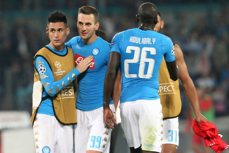 Napoli's (from L) Jose Maria Callejon, Arkadiusz Milik, Kalidou Koulibaly and Faouzi Ghoulam celebrate at the end of their UEFA Champions League Group B match, at San Paolo stadium in Naples, on September 28, 2016