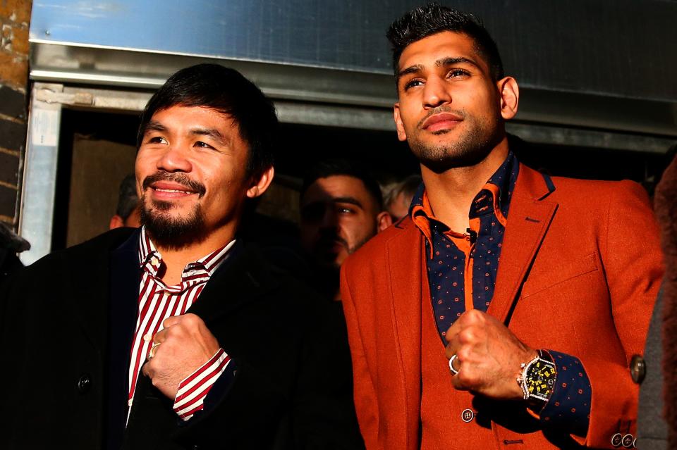 Manny Pacquiao (L) and Amir Khan pose after holding discussions at the Fitzroy Lodge Amateur Boxing Club in London about the possibility of a future fight. (Getty)