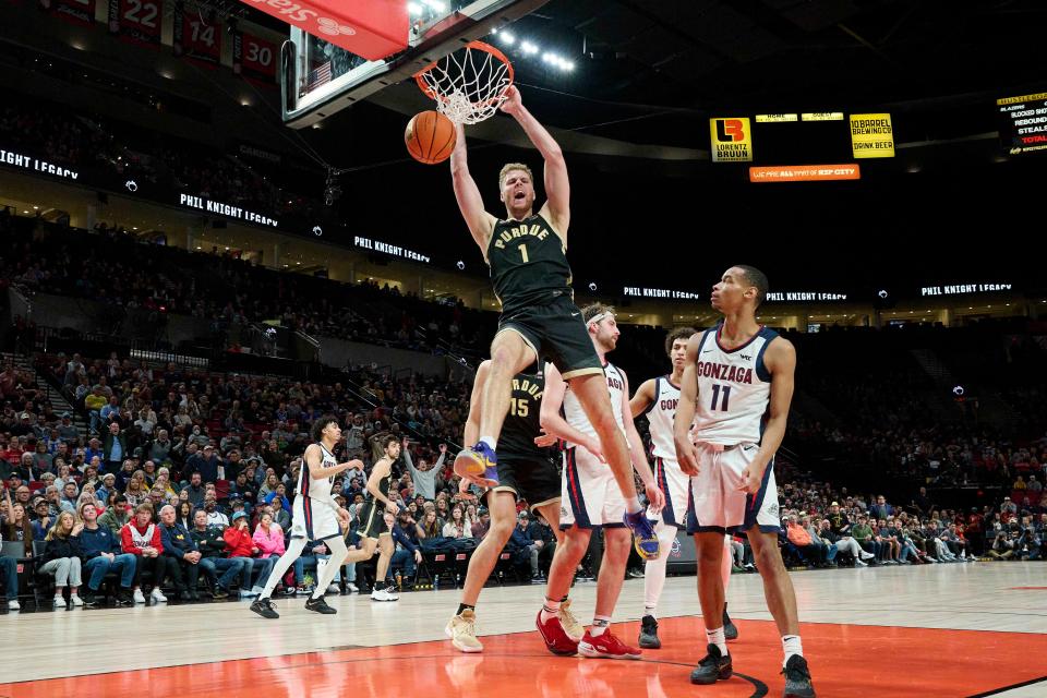 Nov 25, 2022; Portland, Oregon, USA; Purdue Boilermakers forward Caleb Furst (1) dunks the basketball during the second half against Gonzaga Bulldogs guard Nolan Hickman (11) at Moda Center. Purdue won the game 84-66. Mandatory Credit: Troy Wayrynen-USA TODAY Sports