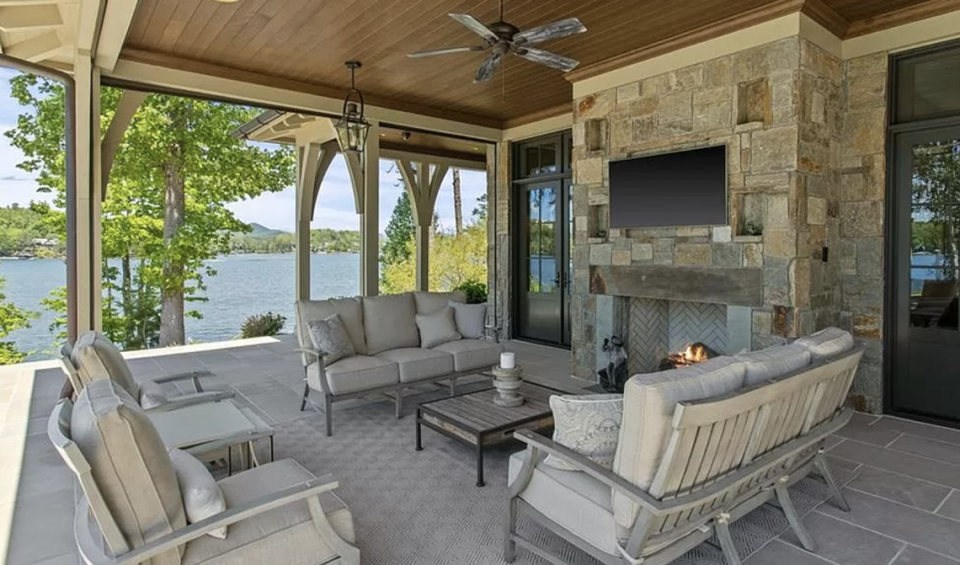 A covered porch overlooks the pool and Lake Keowee.