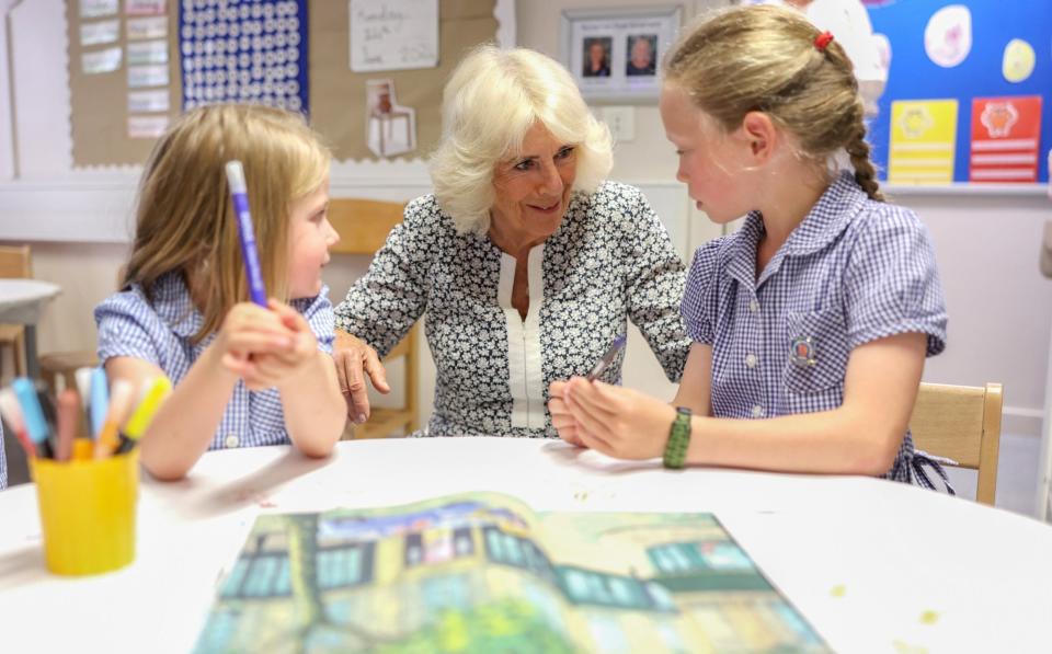 The Queen talks to two young pupils at Christ Church CofE primary school