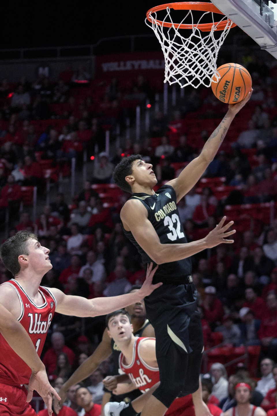 Colorado guard Nique Clifford (32) goes to the basket as Utah forward Ben Carlson (1) defends during the first half of an NCAA college basketball game Saturday, Feb. 11, 2023, in Salt Lake City. (AP Photo/Rick Bowmer)