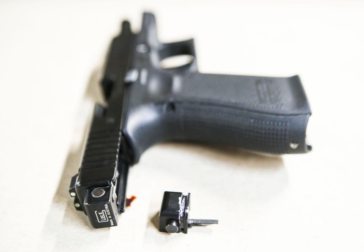 An illegal conversion device for a Glock hand pistol. The small piece can convert a semi-automatic pistol into a fully automatic one, which will continue firing as long as the trigger is pulled. The effect is much like firing an Uzi.