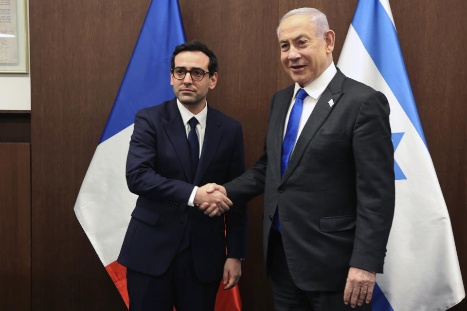 Israeli Prime Minister Benjamin Netanyahu, right, shakes hands with France's Foreign Minister Stephane Sejourne during their meeting in Jerusalem Monday, Feb. 5, 2024. 5, 2024. (Gil Cohen-Magen/Pool via AP)