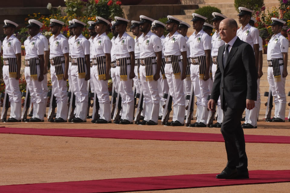 German Chancellor Olaf Scholz, inspects a joint military guard of honour during his ceremonial reception at the Indian presidential palace in New Delhi, India, Saturday, Feb. 25, 2023. (AP Photo/Manish Swarup)