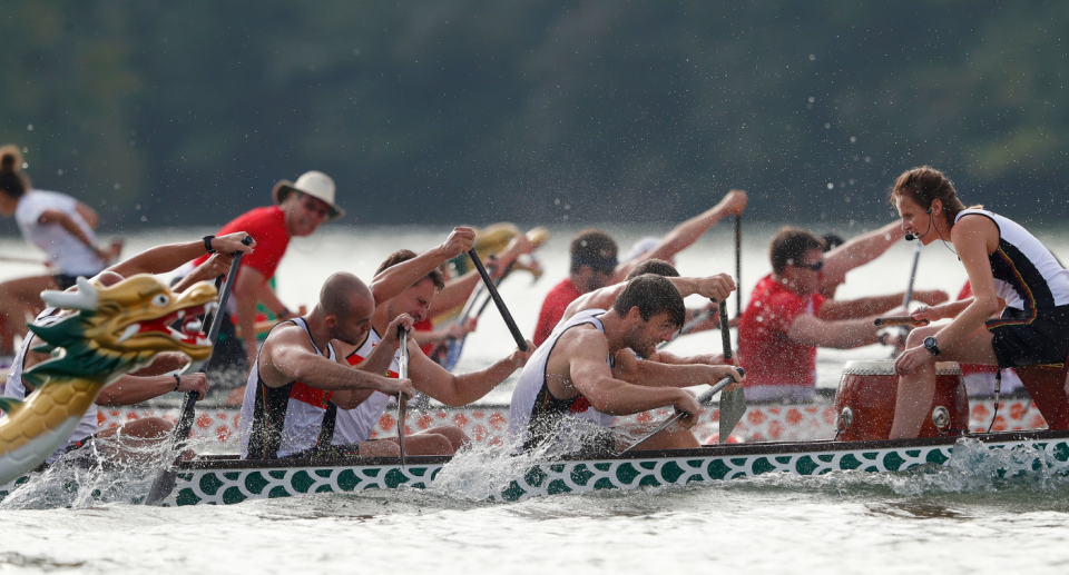 In this Thursday, Sept. 13, 2018 photo, a dragon boat crew from Germany paddles for the finish line during a 500-meter heat at the ICF Dragon Boat Championships, in Gainesville, Ga. (AP Photo/John Bazemore)