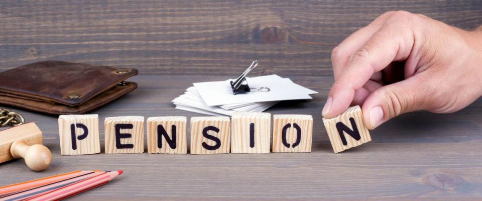 pension. Wooden letters on dark background