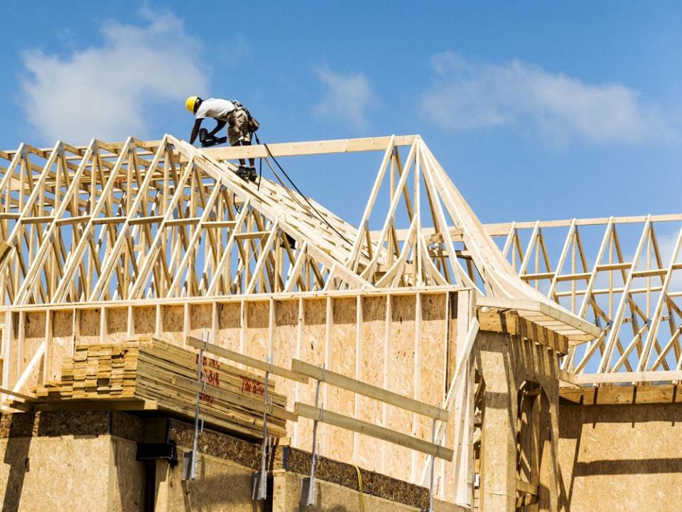 FILE PHOTO: A construction worker works on a new house being built in Vaughan